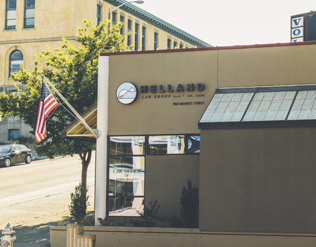 This is an image Helland Law Group's office, where Tacoma Attorneys Robert Helland, Barb McCainville, and Andrew Helland have a general law practice. The photo features a compact, modern building photographed on a sunny da