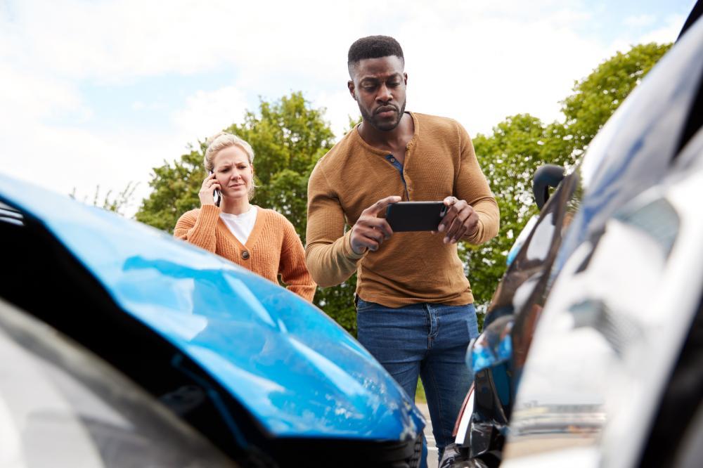 Man taking photos after a car accident collision
