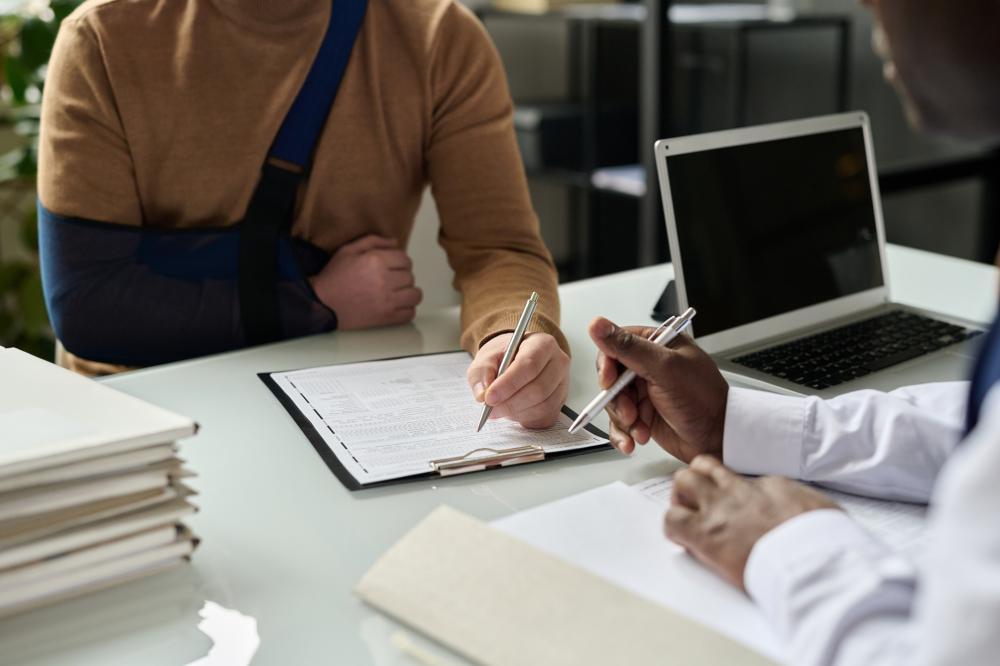Client fills out paperwork with personal injury attorney.